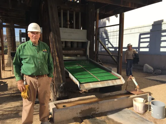 Charlie Connell standing in front of the Swallow Mine stamp mill