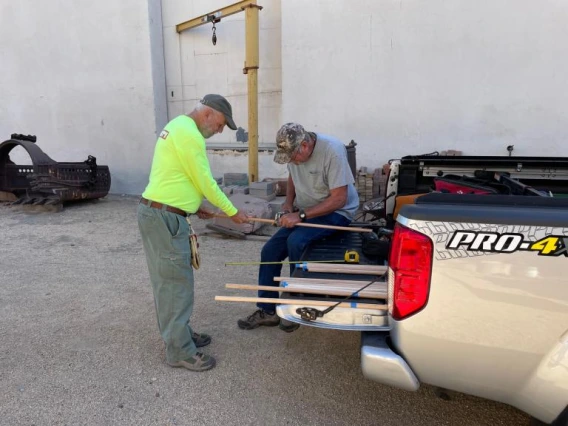 Event preparation: cutting dowel rods for the display cases inside.