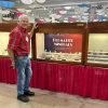 Museum Advisory Council member Les Presmyk standing next to our display case at the Tucson Convention Center.